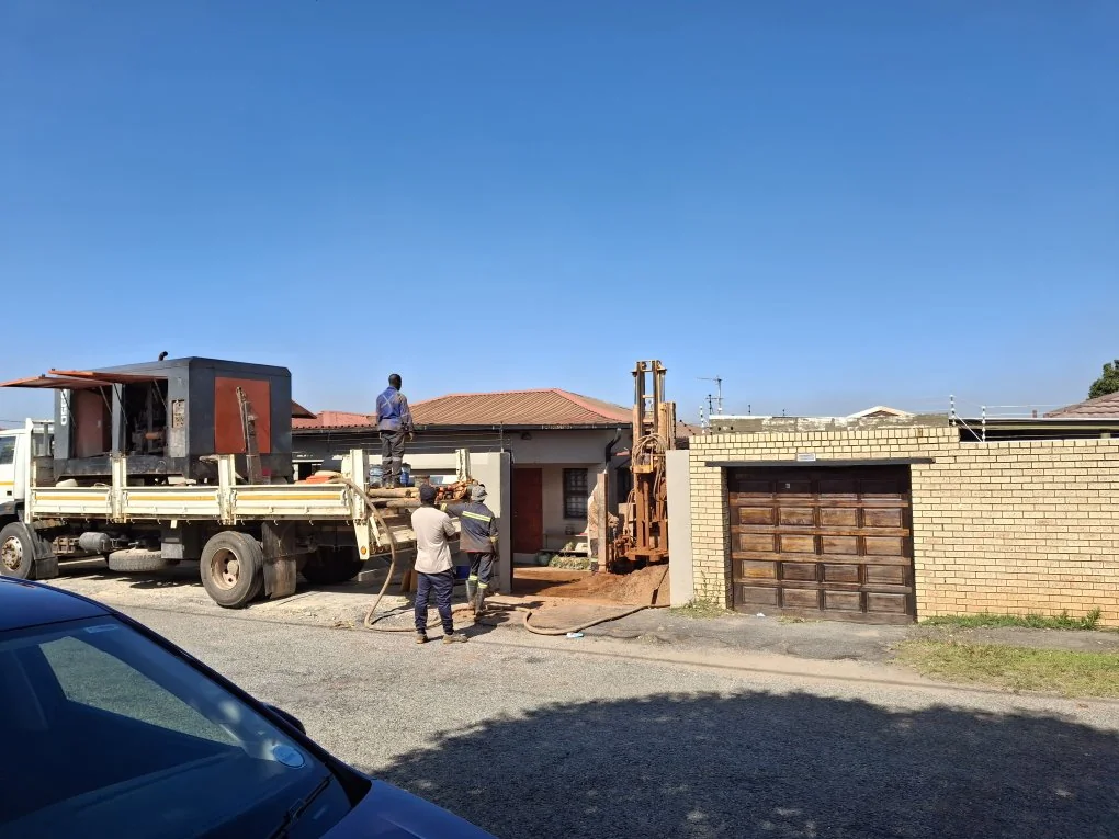 Industrial borehole drilling rig operating on a construction site in Gauteng